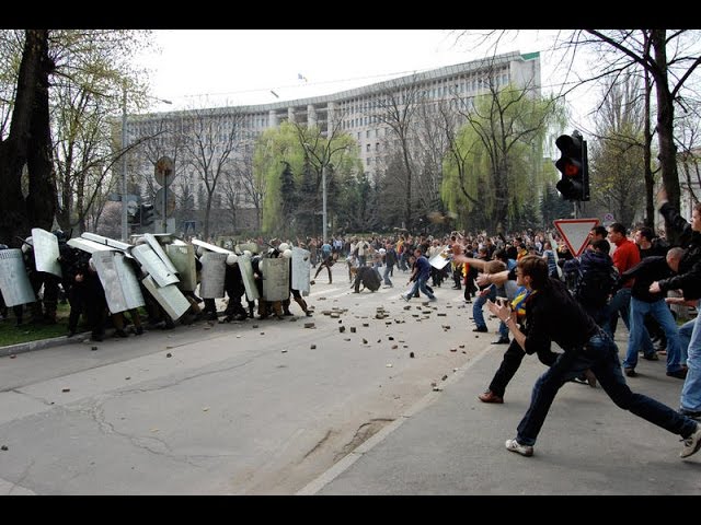 People throwing stones near parliamentary and presidential buildings during 2009 protests in Moldova. Source: RFE/RL ~